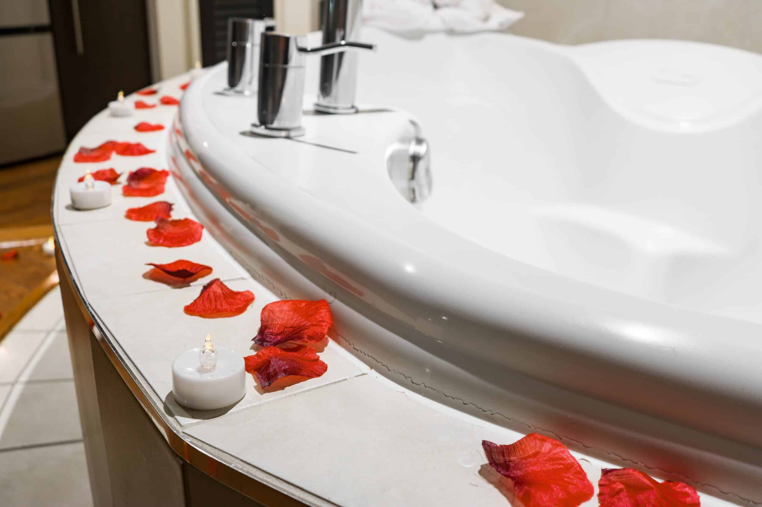 Luxury tub enhancement with rose petals at Sterling Inn & Spa in Niagara Falls Romantic soaking tub with rose petals and candles at Sterling Inn & Spa, Niagara Falls Ontario