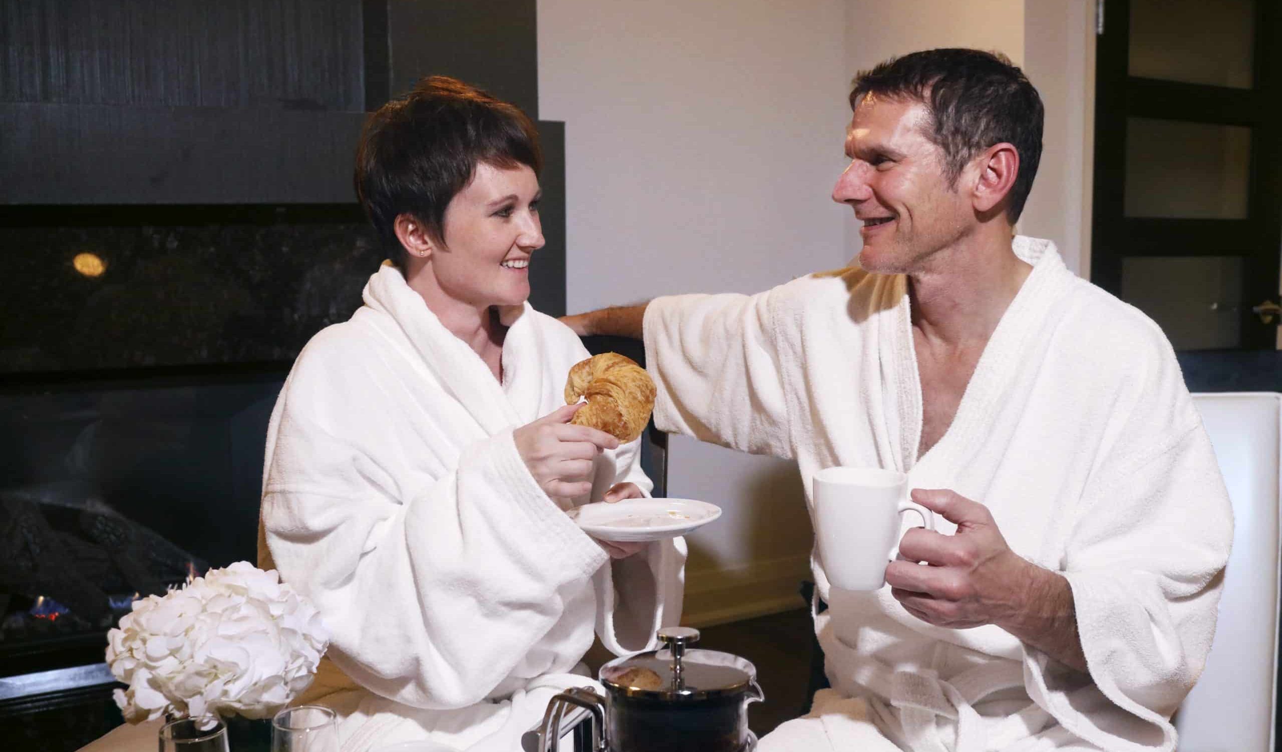 Sterling-Breakfast-in-Bed Couple enjoying breakfast in a luxurious suite at Sterling Inn & Spa